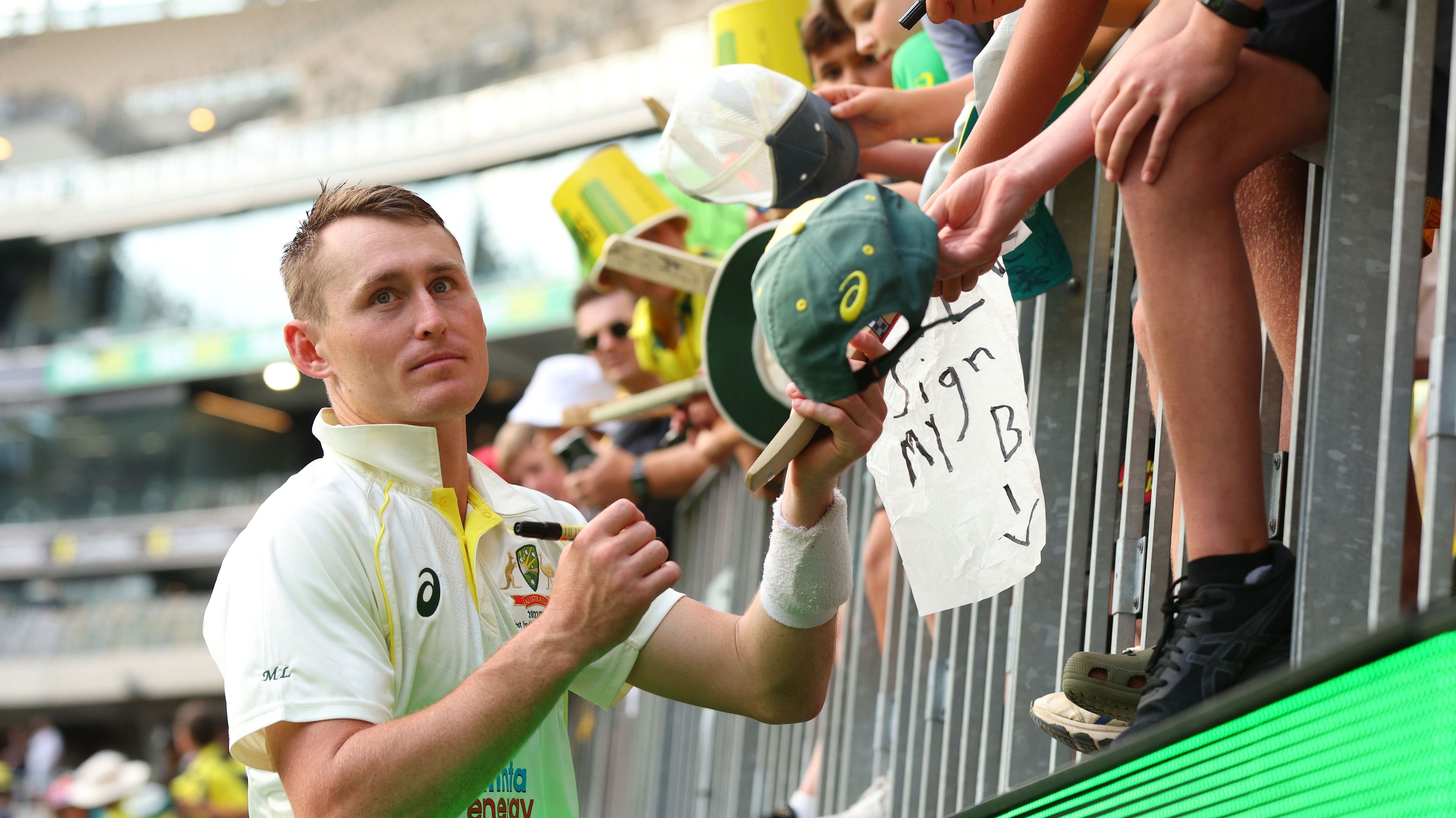 Marnus Labuschagne signs autographs after scoring a century on day one of the Perth Test against West Indies.