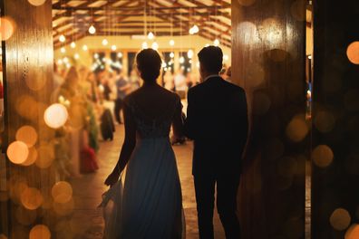 Bride and groom entering their reception.