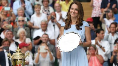 Roger Federer of Switzerland is about to be presented with the runners-up trophy by the Duchess of Cambridge in 2019. 