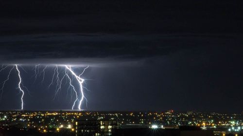 A lightning storm over the sea shot from a balcony in Adelaide's CBD.