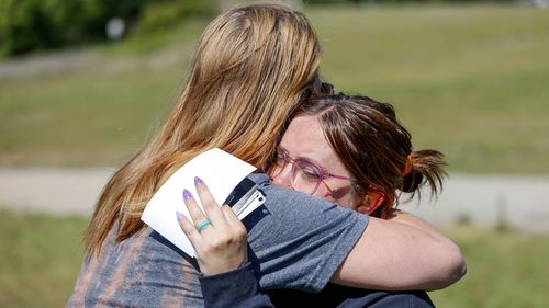 Ashleigh Webster hugs family friend Shannon Dillon at her home in Henryetta, Okla., Tuesday, May 2, 2023. (Nathan J. Fish/The Oklahoman via AP)