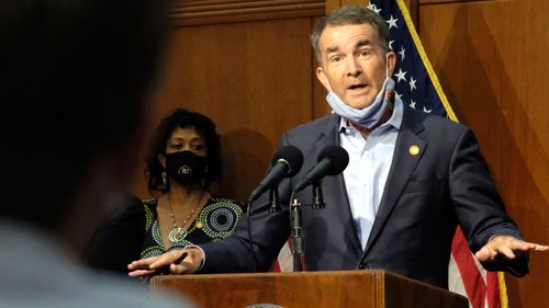 Virginia Gov. Ralph Northam answers a reporter's question during a news briefing in Richmond. Members of anti-government paramilitary groups discussed kidnapping Virginia's governor during a June meeting in Ohio, an FBI agent testified