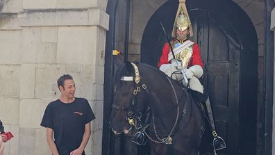 King's Guard touching gesture for tourist