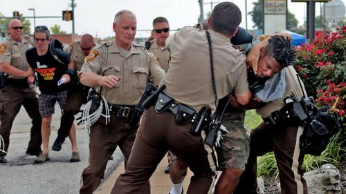 A man is arrested as the protests enter a second week. (AAP)