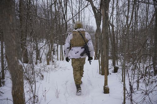An Ukrainian serviceman heads to an advanced position on the front line in the Luhansk area, eastern Ukraine, Thursday, Jan. 27, 2022. 