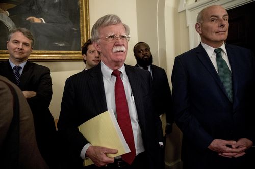 National security adviser John Bolton watches on as Mr Trump defended his comments. Picture: AAP