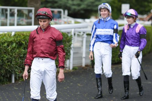 Jockeys wear black armbands in respect of BBC Racing radio commentator John Hunt 