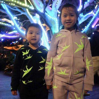 Sydney mum creates glow in the dark tracksuits for kids at Vivid. 