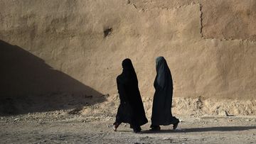 Afghan women walk along a street in Lashkar Gah, the capital city of Helmand province in Afghanistan. (AFP)