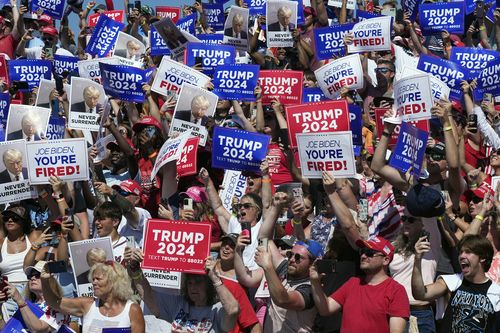 Supporters cheer as Republican presidential candidate former President Donald Trump arrives at a campaign rally in Chesapeake