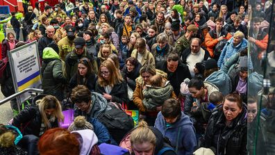 People who fled the war in Ukraine walk towards a humanitarian train to relocate refugees to Berlin in Krakow, Poland. 