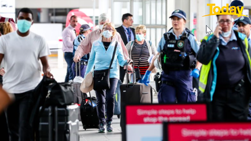 Buses taking people away for quarantine after they have arrived home from overseas. at Sydney airport in a file photo.