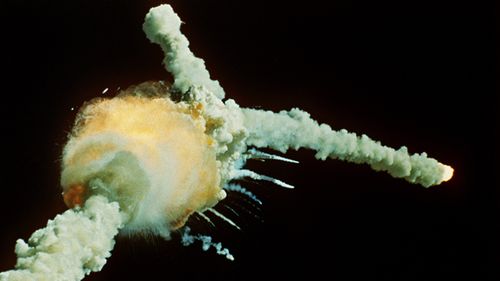 The space shuttle Challenger explodes shortly after lifting off from Kennedy Space Center 