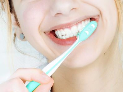 Close up of woman brushing teeth