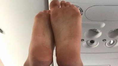 Dirty feet on a plane headrest