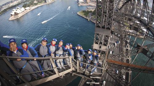 Chinese tourists climb the Sydney Harbour Bridge.