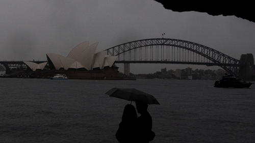 People walk in the rain at Mrs Macquaries Chair during increased storm activity in Sydney Saturday, 8 October 2022