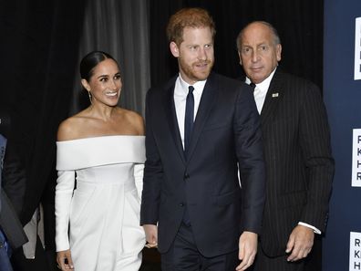 Meghan, Duchess of Sussex, left, and Prince Harry, center, attend the Robert F. Kennedy Human Rights Ripple of Hope Awards Gala at the New York Hilton Midtown on Tuesday, Dec. 6, 2022, in New York. (Photo by Evan Agostini/Invision/AP)