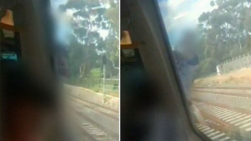 A shocked commuter filmed as a man clung to the outside of a train after a door failed to open.