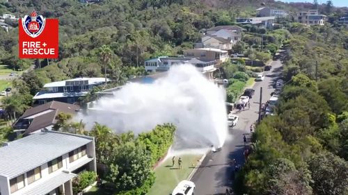 The burst main sent water gushing into the air.