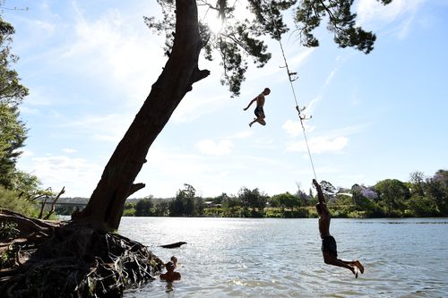 Local kids cool off in the Nepean River at Penrith as the temperature reached 39.3 degrees in 2014. (AAP)
