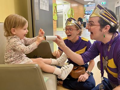 Mia Rose Steffe laughs with the Starlight Captains in hospital.
