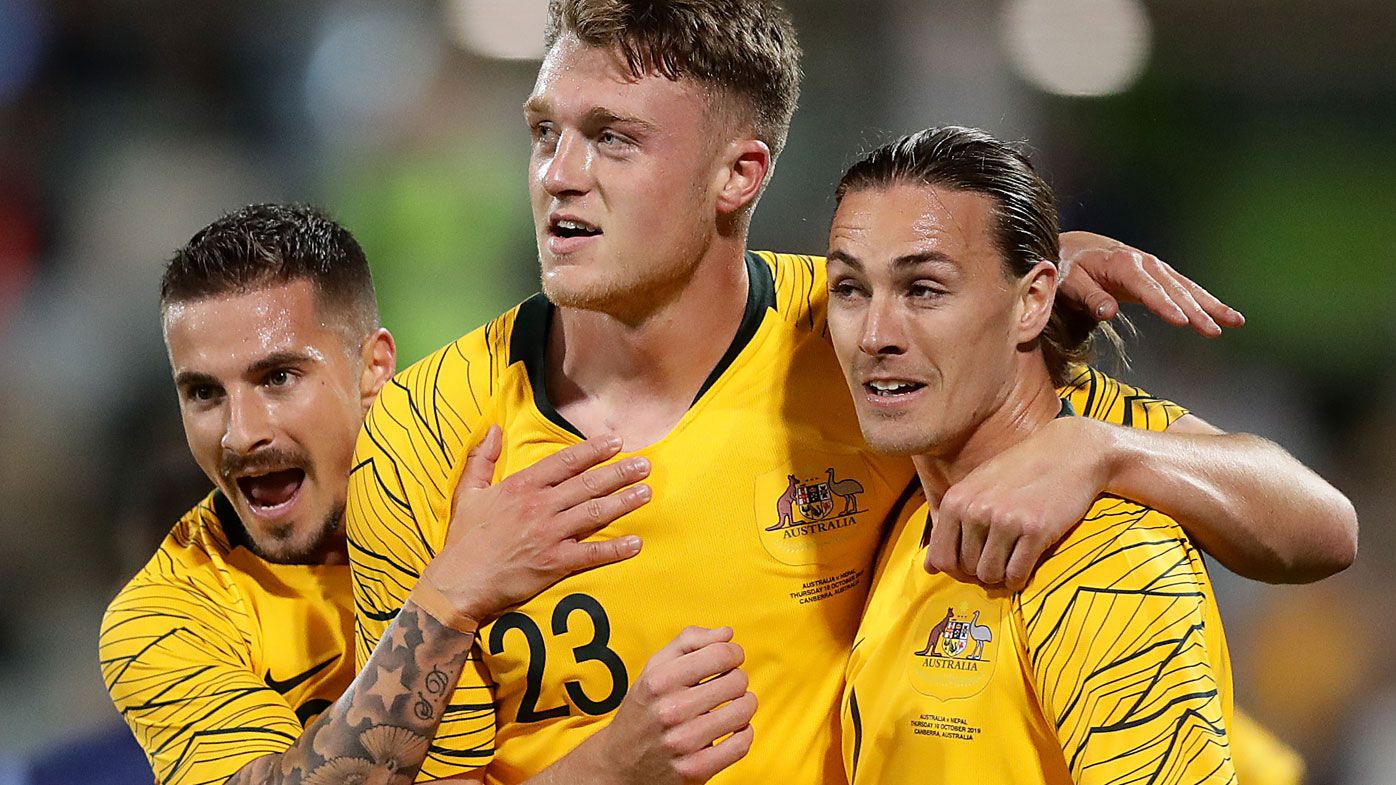 Harry Souttar of the Socceroos celebrates scoring a goal with teammates
