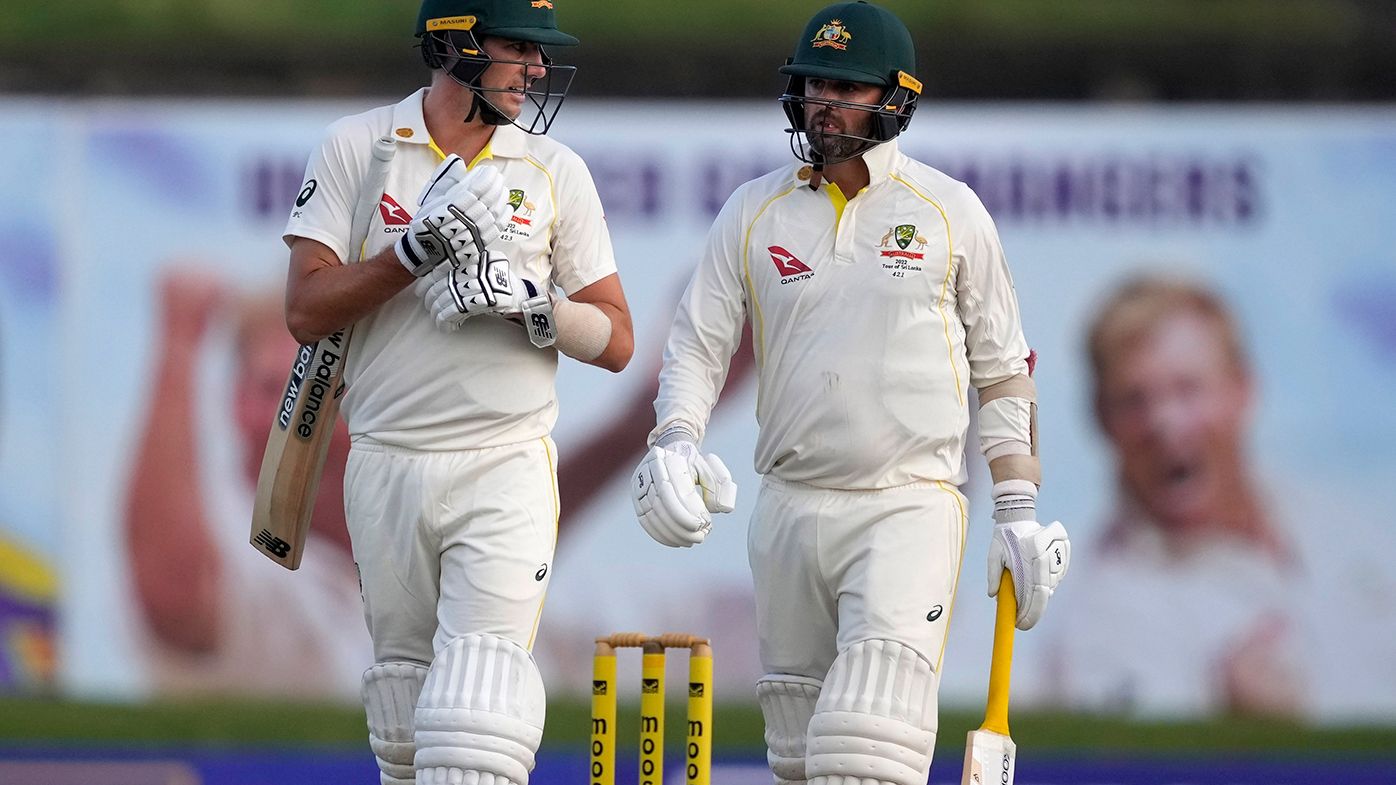 Pat Cummins and Nathan Lyon leave the field after bad light stopped play on day two in Galle.