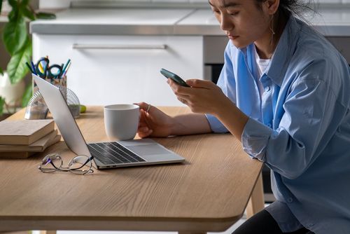 Woman chesk social media on her phone before starting work