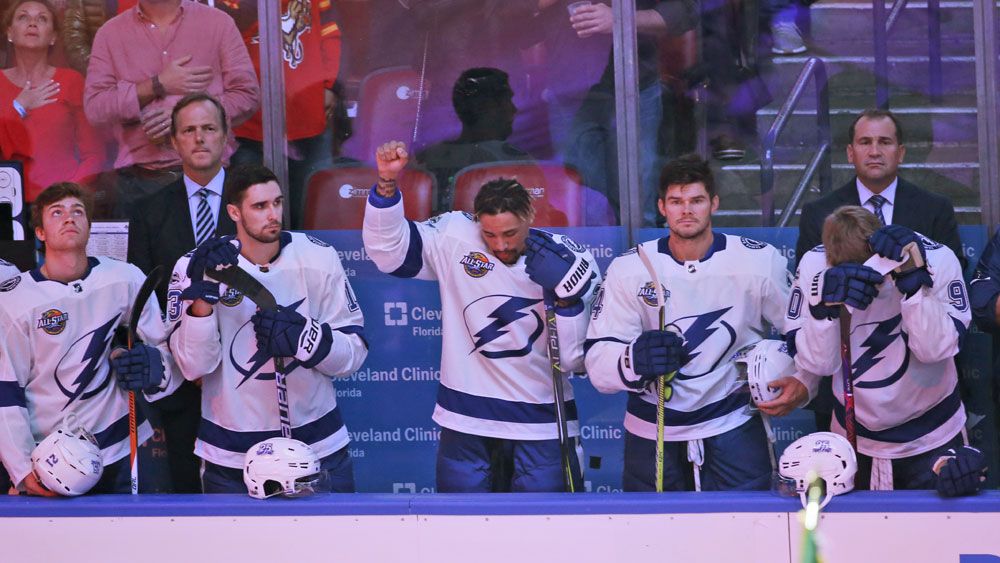 NHL's Tampa Bay forward JT Brown raises fist in silent protest during US anthem