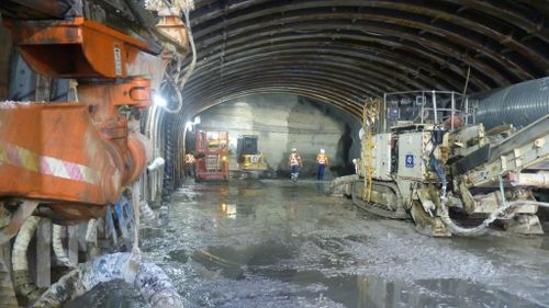 Workers underground carve out a tunnel as part of the Wynyard Walk project. (Supplied)