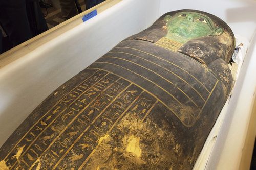 An ancient wooden sarcophagus is displayed during a handover ceremony at the foreign ministry in Cairo, Egypt, Monday, Jan. 2, 2023. An ancient wooden sarcophagus that was featured at the Houston Museum of Natural Sciences was returned to Egypt after U.S. authorities determined it was looted years ago, Egyptian officials said Monday. (AP Photo/Mohamed Salah)