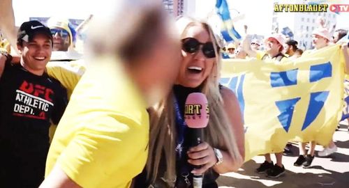 Swedish reporter Mahlin Wahlberg was reporting before her country's opening match against South Korea, when a fan leapt from the crowd and kissed her. (AftonbladET)