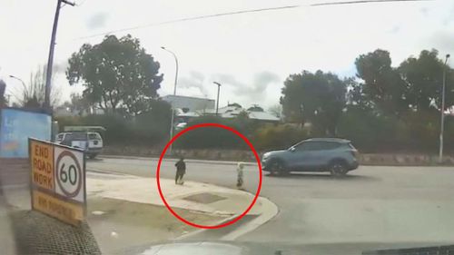 Shocking footage shows two young children wandering towards a busy road in Adelaide after leaving a daycare centre unsupervised.