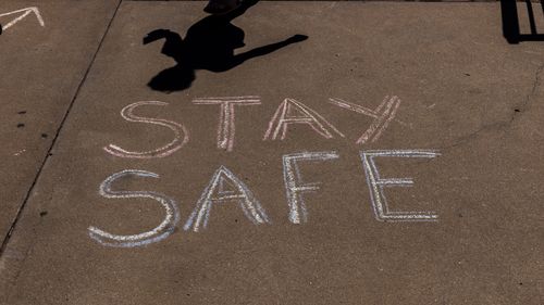 A stay safe sign is chalked on the pavement in Broken Hill.