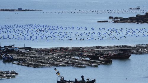 A boat moves through the water at the 68-nautical-mile scenic spot, the closest point in mainland China to the island of Taiwan, in Pingtan in southeastern China's Fujian Province, Friday, Aug. 5, 2022. China conducted "precision missile strikes" Thursday in waters off Taiwan's coasts as part of military exercises that have raised tensions in the region to their highest level in decades following a visit by U.S. House Speaker Nancy Pelosi. (AP Photo/Ng Han Guan)