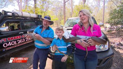 Family catching snakes.