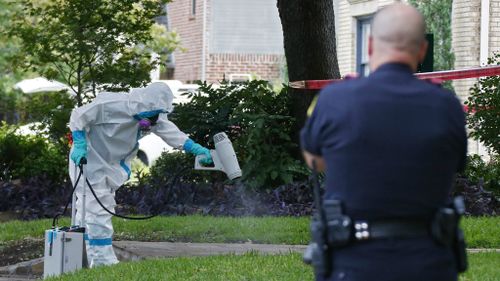 A hazmat crew cleans outside Ms Pham's apartment. (AAP)