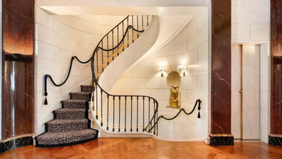 The grand reception level with its marble pillars and stately stairs.