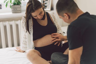 Young beautiful couple expecting a baby. Happy family life concept