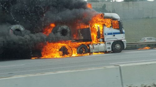 The truck engulfed in flames on the Monash Freeway.