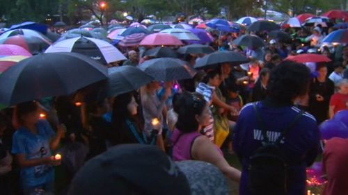 Hundreds braved the rain to hold a vigil for Tiahleigh Palmer at Logan. (9NEWS)
