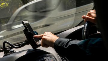 A driver uses their mobile phone.
