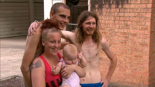 Mr Finn (R) with the family who escaped the burning unit block, and their baby Nevaeh. (9NEWS)