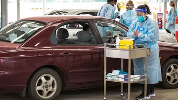 A nurse administers the Pfizer COVID-19 vaccine at a drive through vaccination centre in Melton, Melbourne.