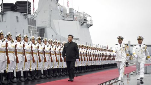 Xi Jinping with foreign naval officers attending a fleet review marking the 70th anniversary of the People's Liberation Army Navy.