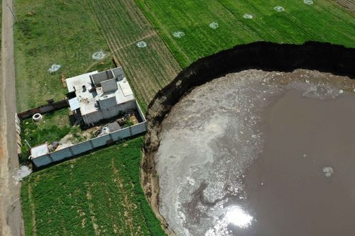 The sinkhole is threatening this home and the occupants have been evacuated. central mexico