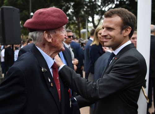President Macron speaks with Legion d'Honneur awardee Bill Mackay. Picture: AAP