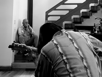 Bruce Willis pictured jamming on the harmonica with friends.