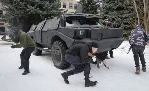 Local residents attend an all-Ukrainian training campaign "Don't panic! Get ready!" close to Kyiv, Ukraine, Sunday, Feb. 6, 2022. Russia has denied any plans of attacking Ukraine, but urged the U.S. and its allies to provide a binding pledge that they won't accept Ukraine into NATO, won't deploy offensive weapons, and will roll back NATO deployments to Eastern Europe. Washington and NATO have rejected the demands. (AP Photo/Efrem Lukatsky)